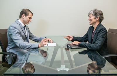Young man in interview with mature woman